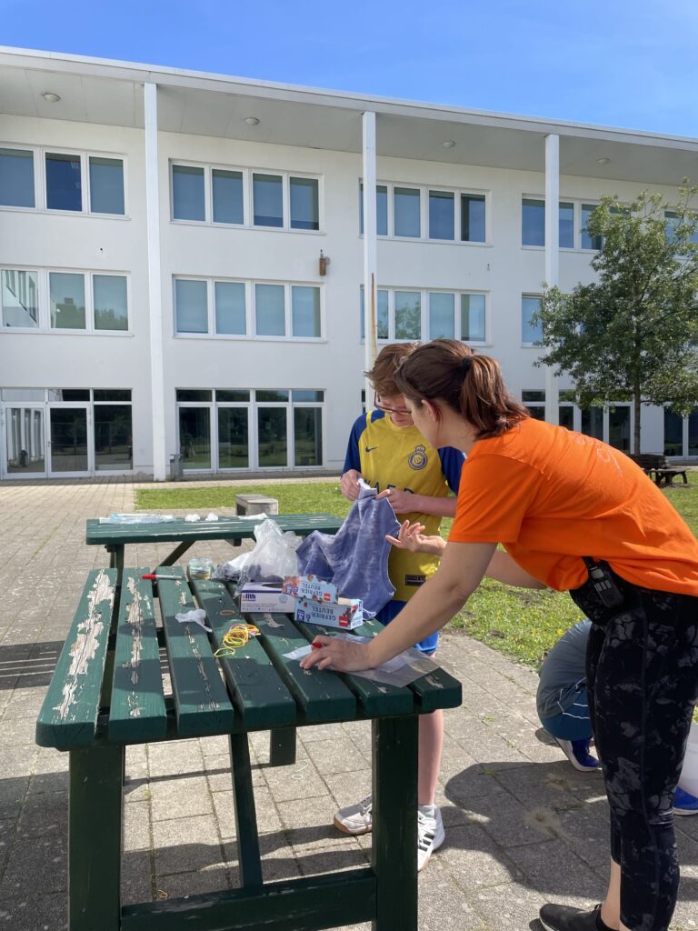 Counselor working on a project with campers